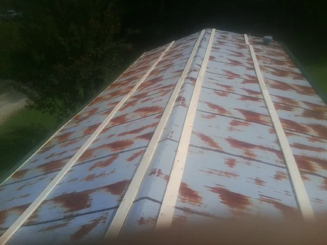 Rusted metal roof panels with new wood purlins before replacement — Storm Damage Roof Repair in Denville by Roofing Brothers